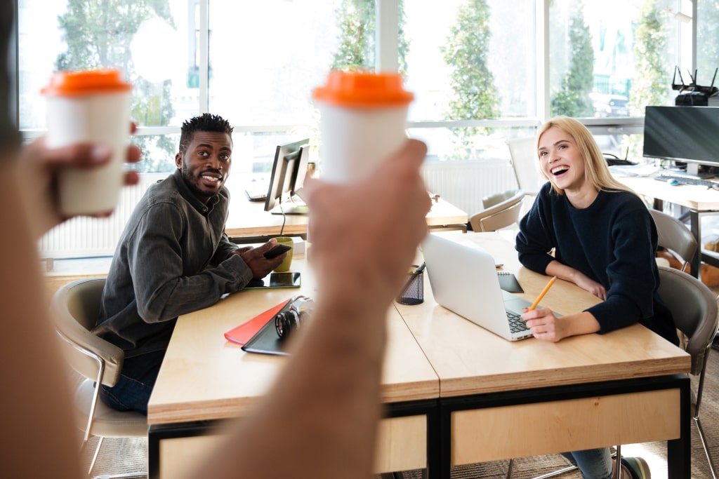 work in marbella smiling young colleagues sitting office coworking